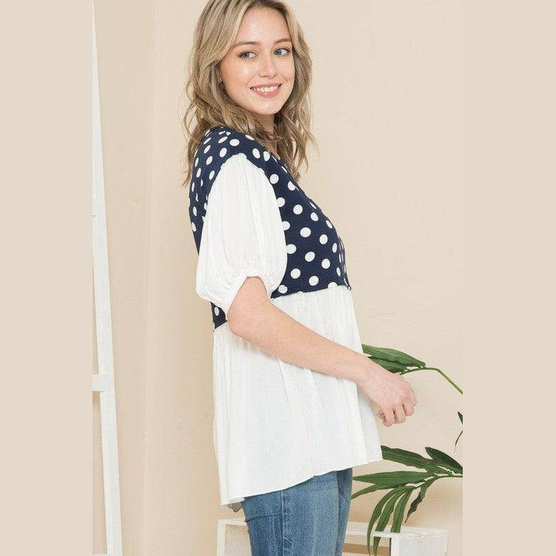 Women's polka dot tunic top in navy and white with short puff sleeves and relaxed fit
