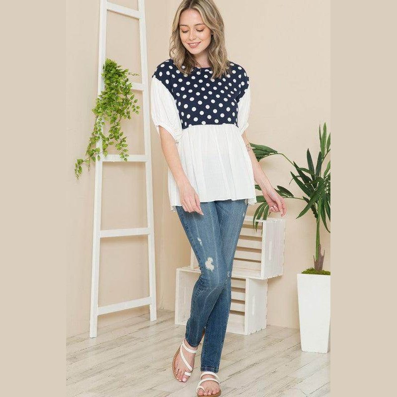 Women's polka dot tunic top from Orange Farm Clothing with navy and white design, perfect for casual outings