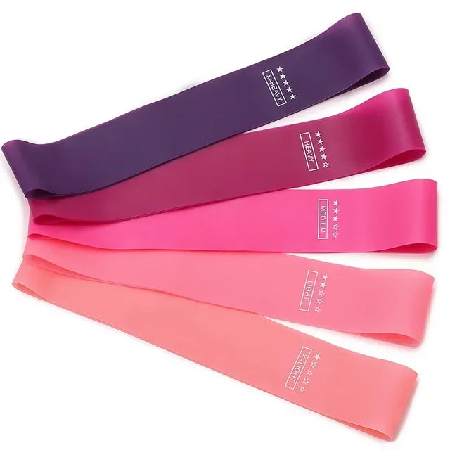 Portable resistance bands for women in pink and purple for workouts