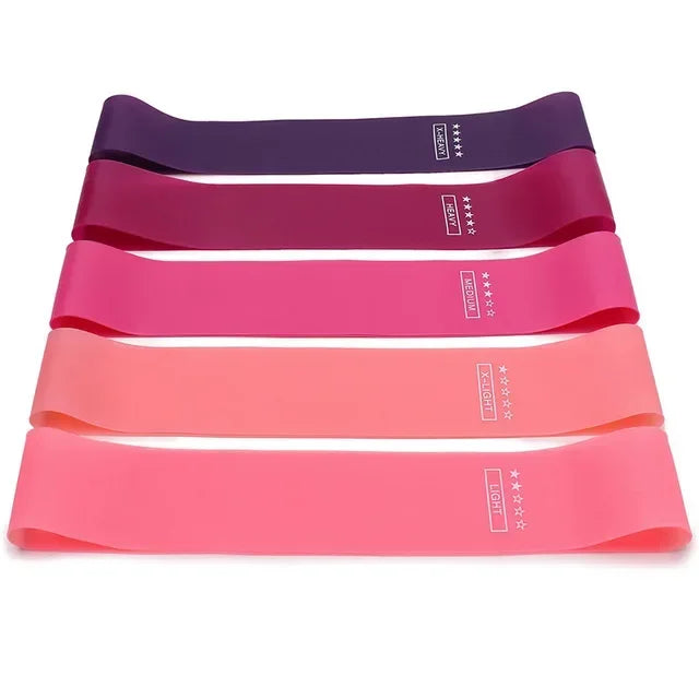 Set of portable resistance bands for women in various shades of pink and purple