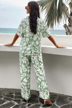 Back view of woman wearing green and white printed short sleeve pants set with abstract leaf pattern