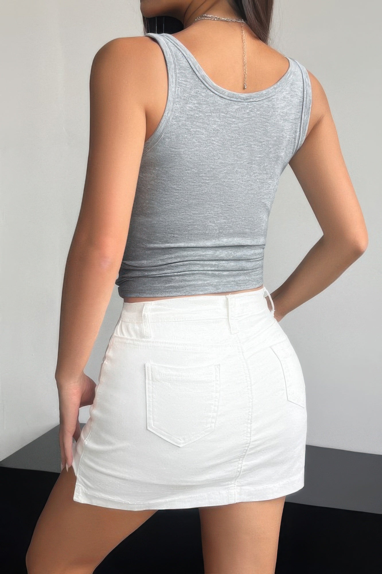 Gray quarter button fit tank for women paired with a white skirt for a stylish summer look