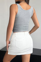 Gray quarter button fit tank for women paired with a white skirt for a stylish summer look
