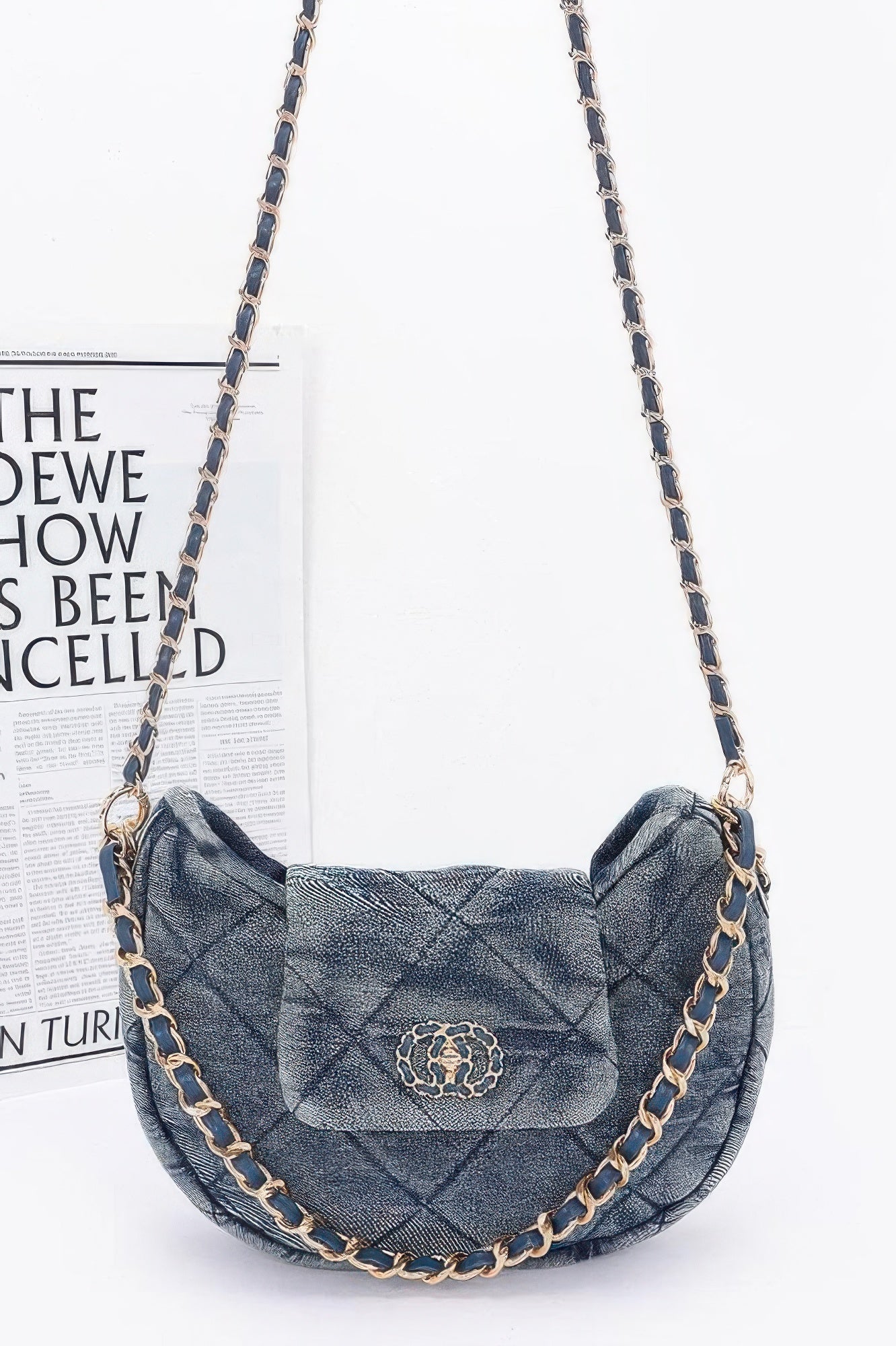 Quilted denim crossbody bag with a stylish chain strap and flap closure for casual wear