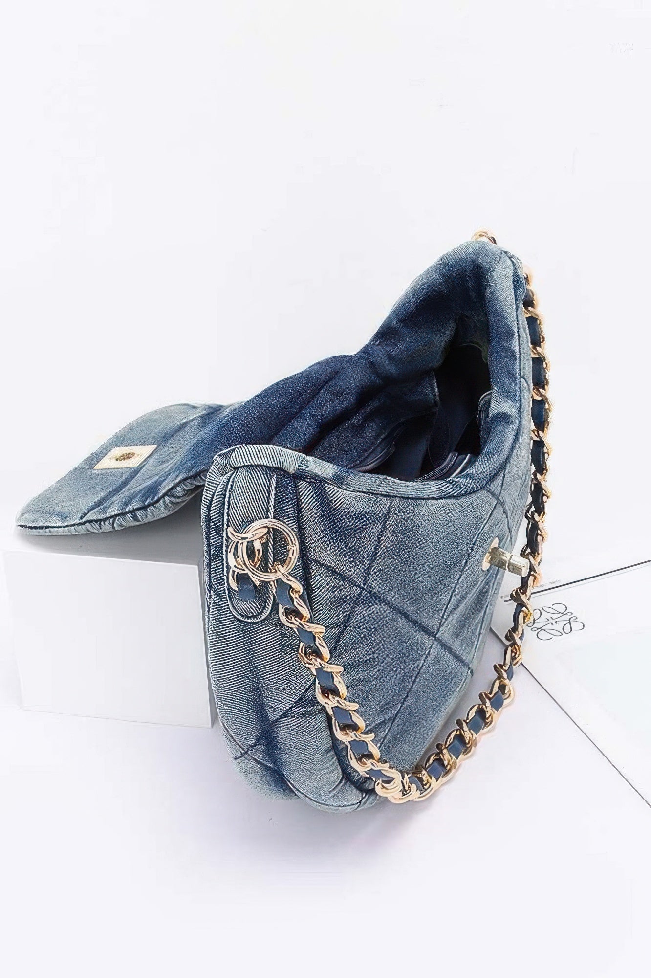 Quilted denim crossbody bag with chain strap and spacious interior for everyday use