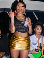 Fashionable woman wearing a gold quilted warm mini skirt at a social event with drinks