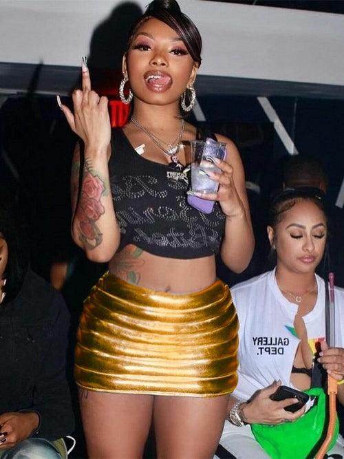 Fashionable woman wearing a gold quilted warm mini skirt at a social event with drinks