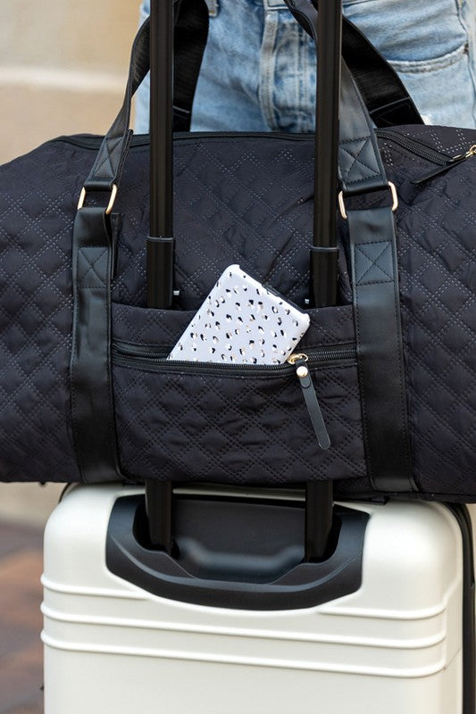 Aili's Corner quilted weekender bag for women with a front pocket on a suitcase handle