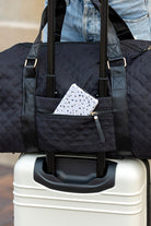Aili's Corner quilted weekender bag for women with a front pocket on a suitcase handle