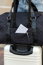 Aili's Corner quilted weekender bag for women with a front pocket on a suitcase handle