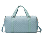 Aili's Corner quilted weekender bag for women in light blue with sturdy handles and adjustable strap