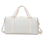 Aili's Corner quilted weekender bag for women in white with sturdy handles and adjustable shoulder strap