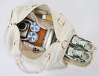 Aili's Corner quilted weekender bag for women packed with sneakers and accessories for travel