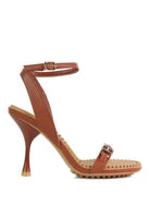 Stylish brown women's heels with a strappy design and a high heel, perfect for formal occasions