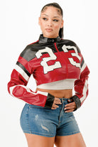 Stylish model wearing a red leather cropped biker jacket with sporty design and cropped fit