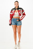 Stylish women's red leather cropped biker jacket paired with denim shorts for a trendy look