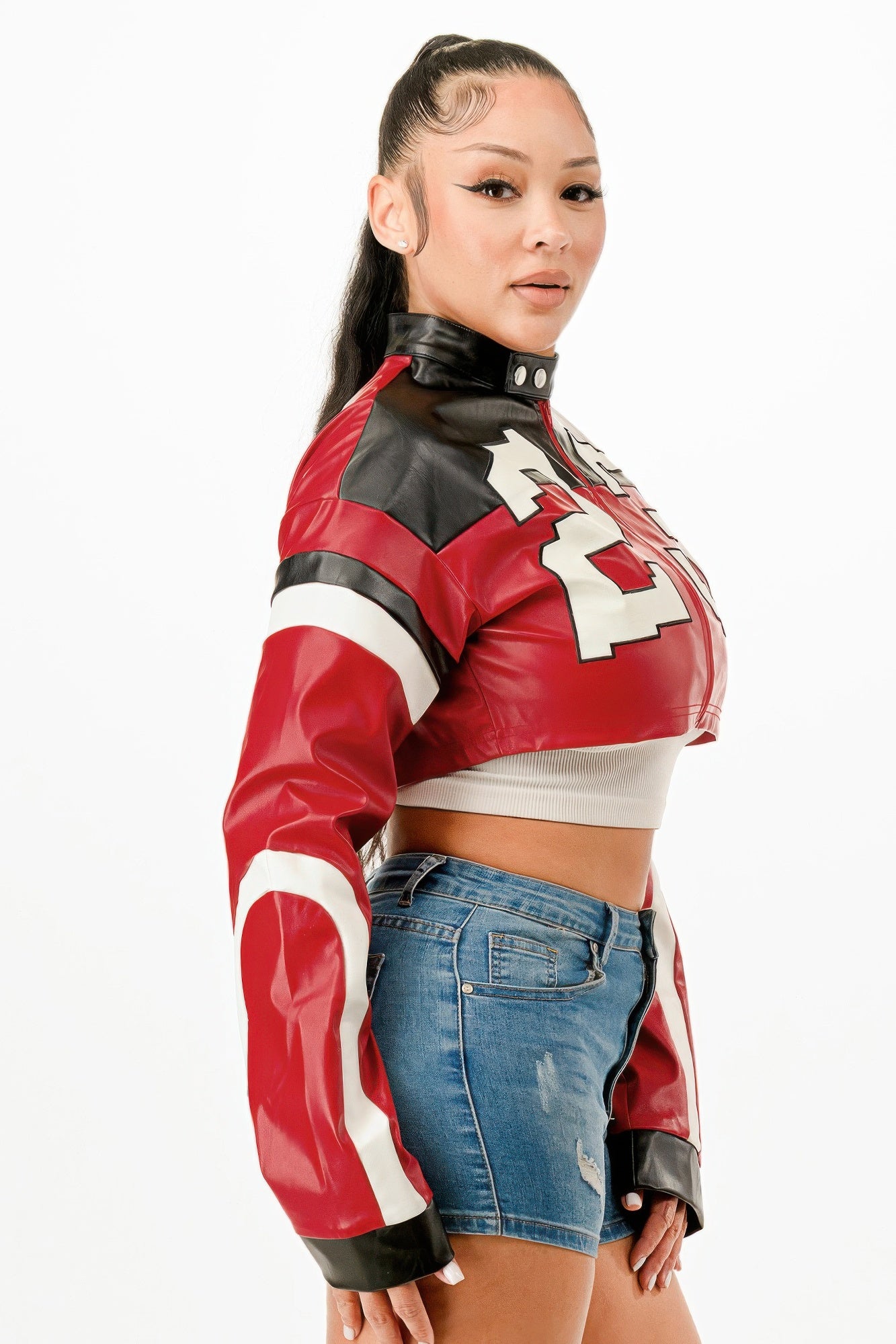 Stylish woman wearing a red leather cropped biker jacket with contrast black details for a trendy look