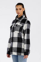 Stylish women's black and white checkered oversized shacket perfect for layering in cooler weather