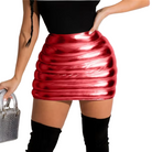 Person wearing a red metallic skirt and black knee-high boots, holding a silver handbag against a plain background.