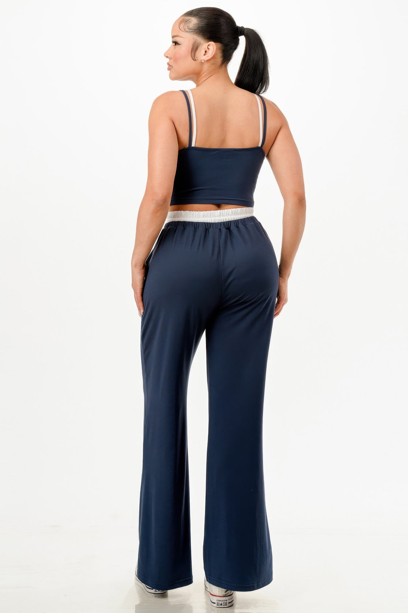 Woman wearing a navy blue relaxed fit tank and jogger set with white straps from VacationGrabs