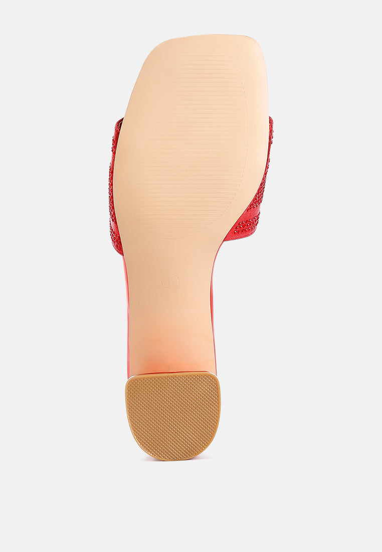 Red women's heels with a textured sole, featuring rhinestone embellished sandals for a stylish look