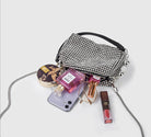 SHOMICOBOUTIQUE rhinestone evening bag with various cosmetics and phone displayed on a light background