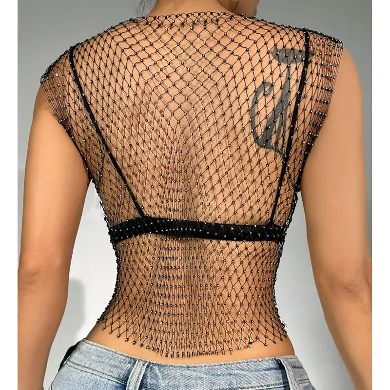 Back view of a rhinestone fishnet crop top shell only worn over skin showing black net design with rhinestone embellishments