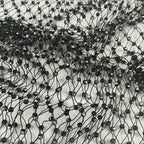 Close-up of black rhinestone fishnet crop top shell only with sparkling details on mesh fabric