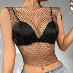 Black rhinestone fishnet crop top shell only worn over a black bra paired with light denim jeans