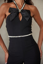 Elegant women's rhinestone halter neck jumpsuit featuring a stylish bow and shimmering details