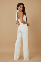 White rhinestone halter neck jumpsuit from VacationGrabs with elegant back design and wide legs