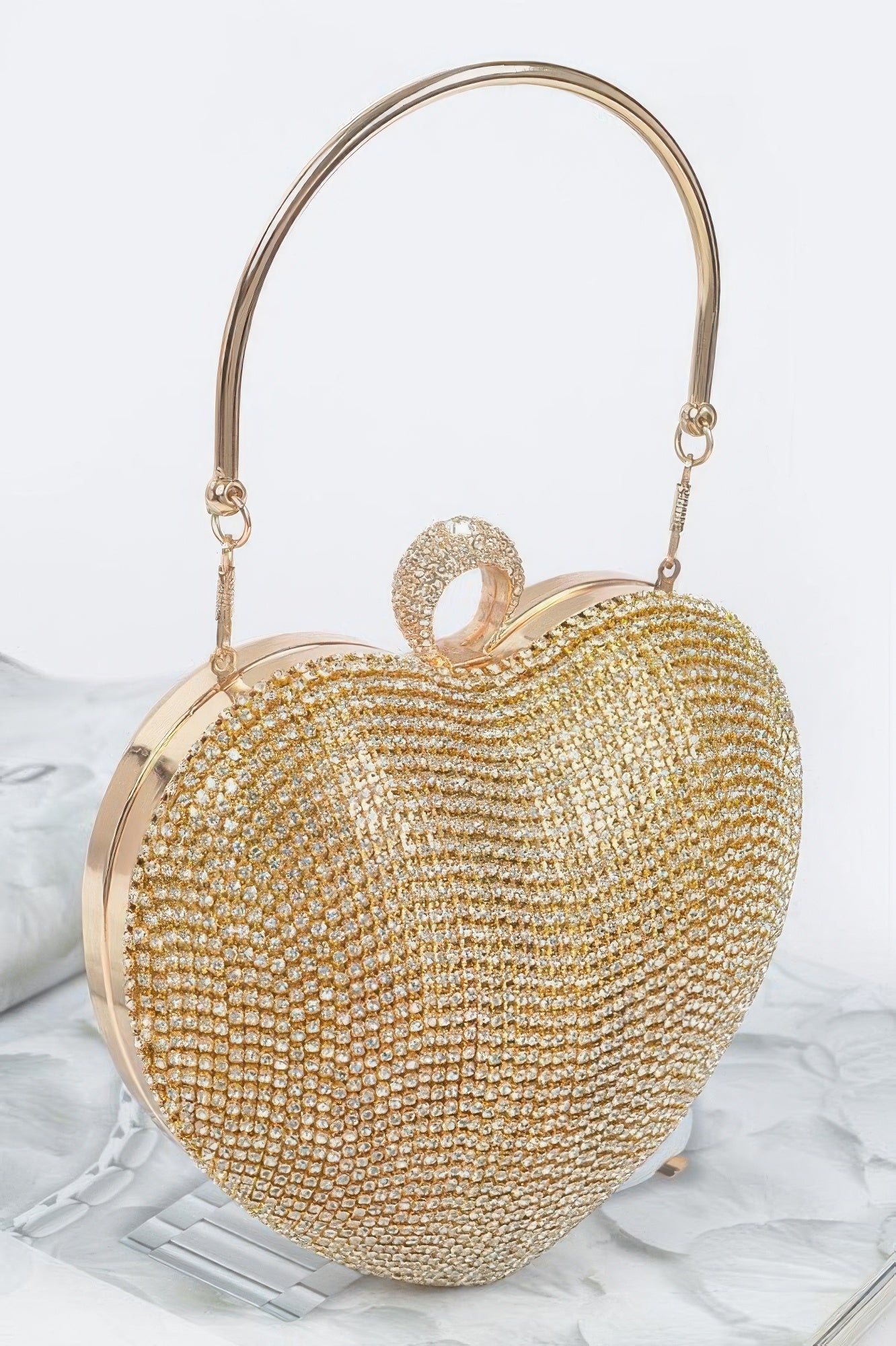 Elegant rhinestone heart shape clutch in gold with a stylish handle for special occasions
