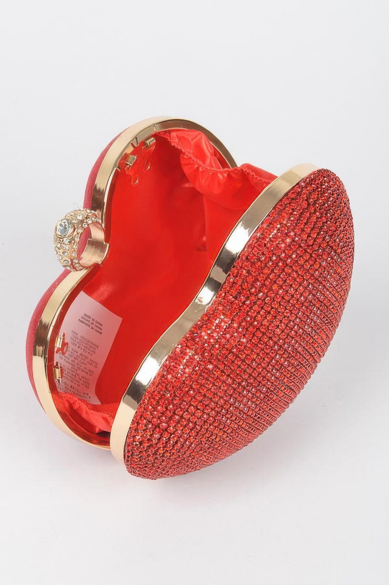 Red rhinestone heart shape clutch with gold detailing and luxurious interior for stylish occasions