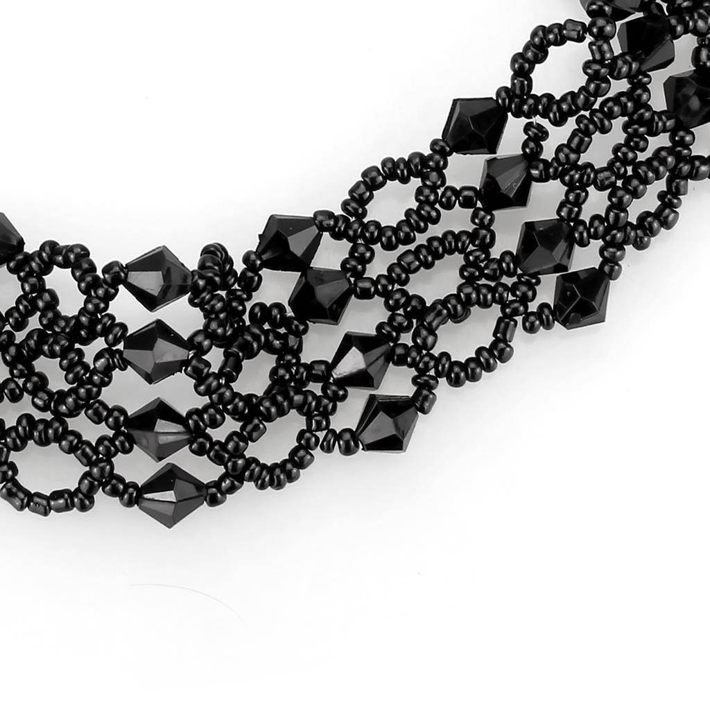 Elegant rhodium brass necklace featuring intricate black beading and geometric shapes