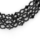 Elegant rhodium brass necklace featuring intricate black beading and geometric shapes
