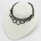 Elegant rhodium brass synthetic necklace with intricate loop design for stylish women