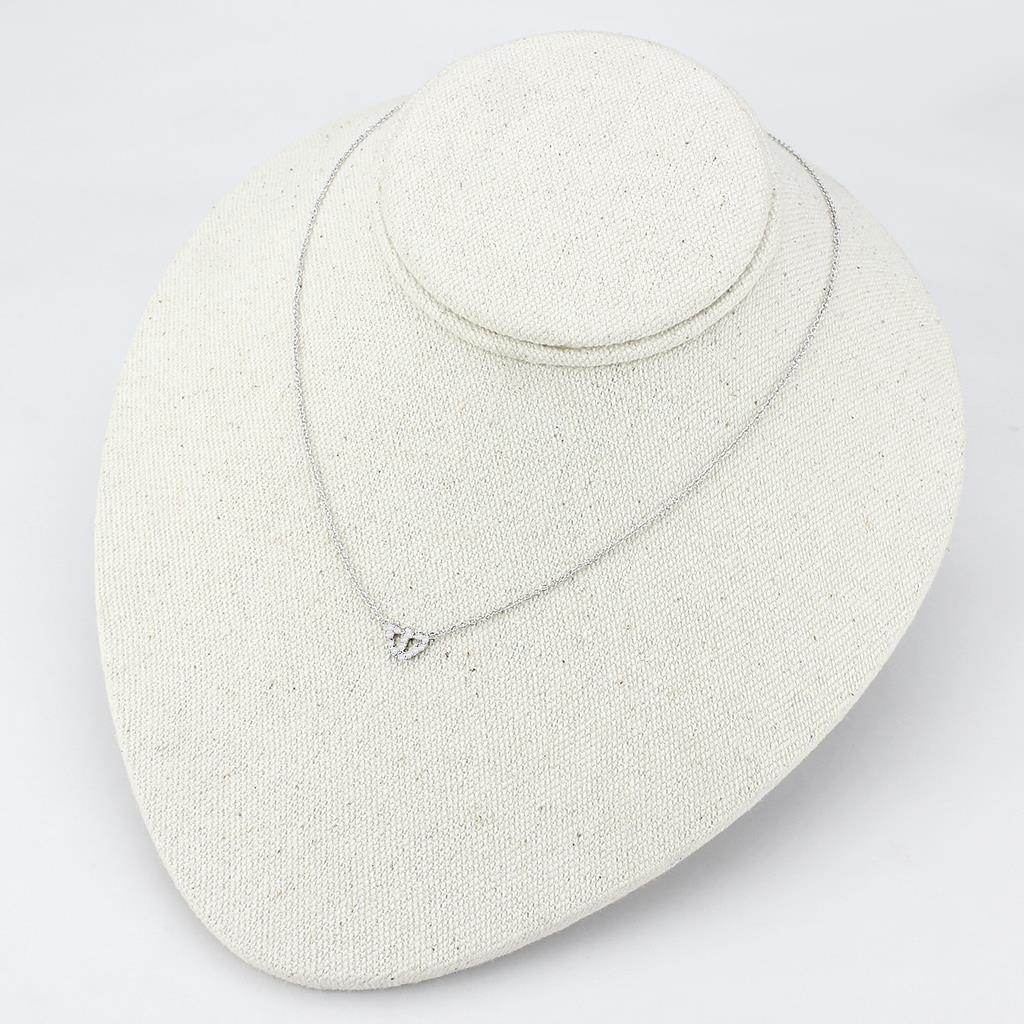 Delicate rhodium crystal heart necklace resting on a display stand for elegant women's jewelry