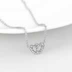Delicate rhodium crystal heart necklace featuring shimmering crystals for elegant style