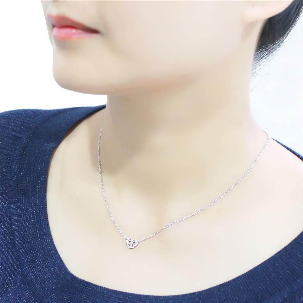 Woman wearing a rhodium crystal heart necklace showcasing its elegant design and sparkle