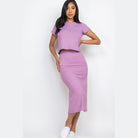 Woman wearing lavender ribbed midi skirt set with short sleeve top and fitted skirt from Capella