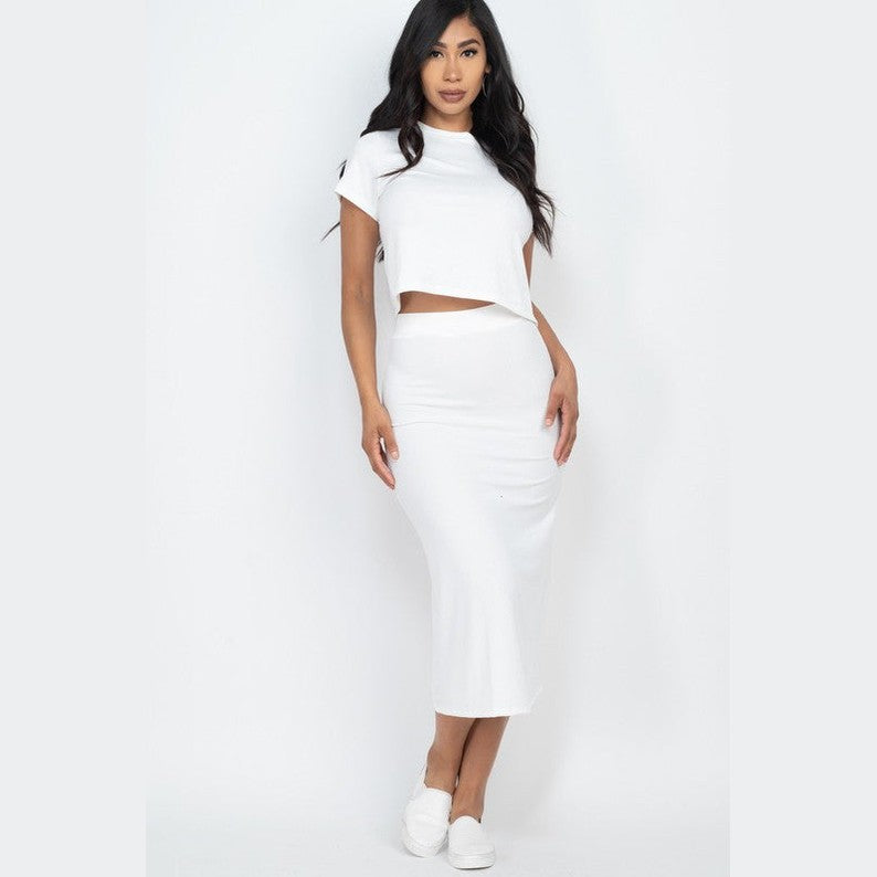Woman wearing white ribbed midi skirt set with short sleeve crop top and matching fitted skirt