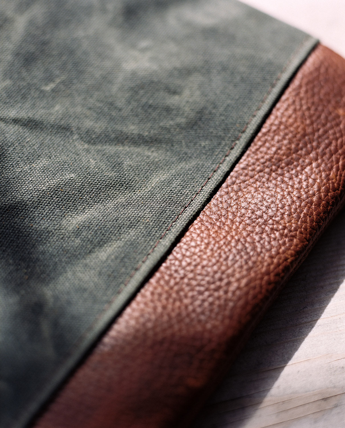 Close-up of Rogue Industries stylish messenger bag for vacations showcasing canvas and leather texture