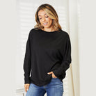 Black women's round neck long sleeve top styled for casual wear with a relaxed fit