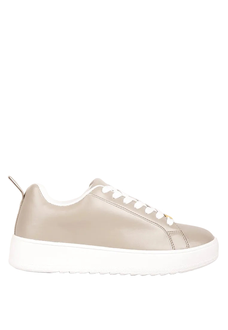 Beige sneaker with white sole on a light gray background