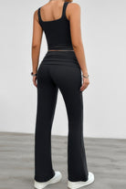 Stylish black ruched summer outfit for women featuring a fitted tank top and flared pants