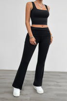 Stylish black ruched summer outfit for women featuring a fitted crop top and flared pants