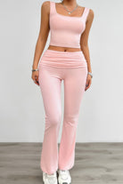 Pink ruched summer outfit for women featuring a fitted crop top and flared pants