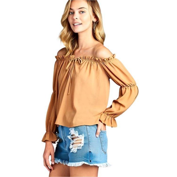 Ivory Felix Ruffled Front Tie Long Sleeve Blouse in tan color, styled with distressed denim shorts