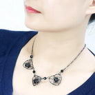 Elegant ruthenium metal necklace with intricate designs and black beads for a stylish look