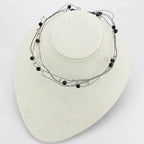 Elegant ruthenium white metal necklace with black beads for a stylish look